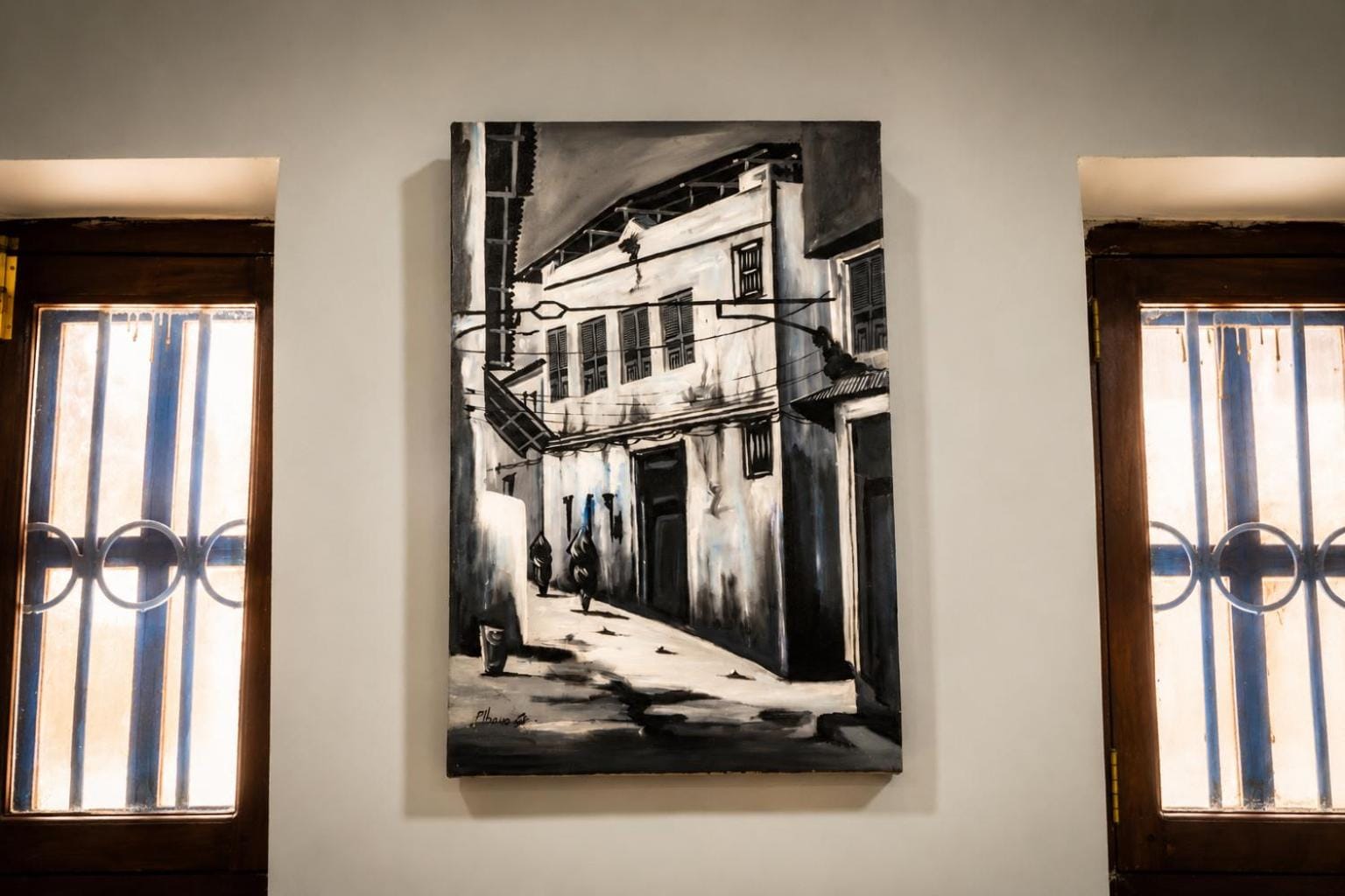 a quiet dormitory room with a jute rug and a black and white photograph of Stone Town