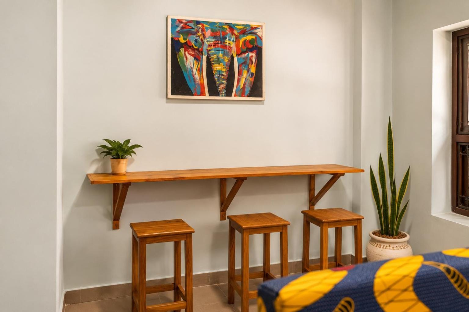 a bunk bed beside a wooden counter with stools