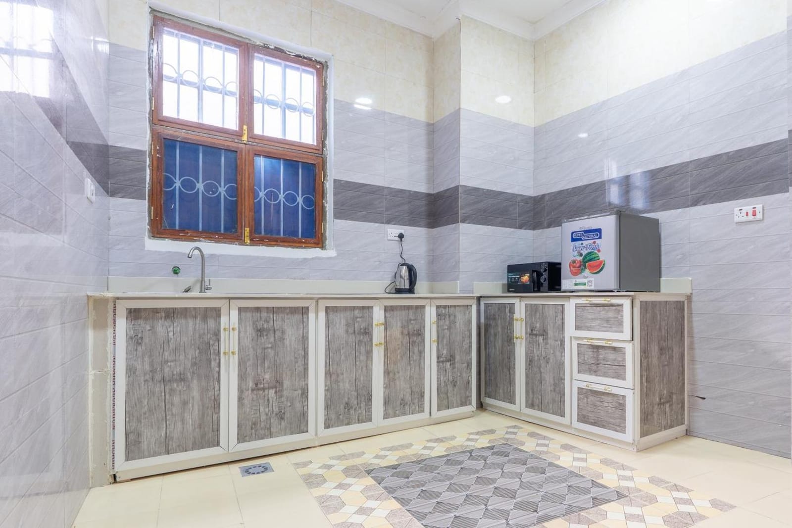 the kitchen counter with a patterned tiled floor